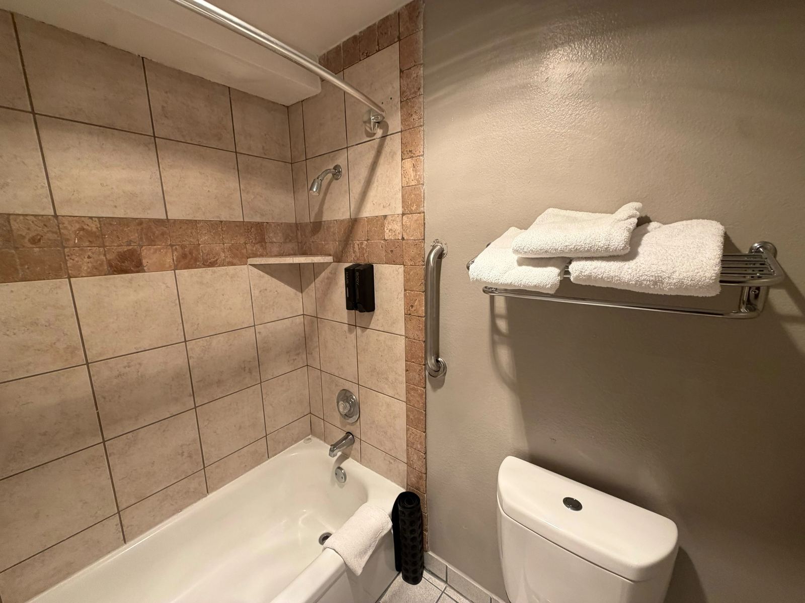 Guest bathroom with tiled bathtub and shower